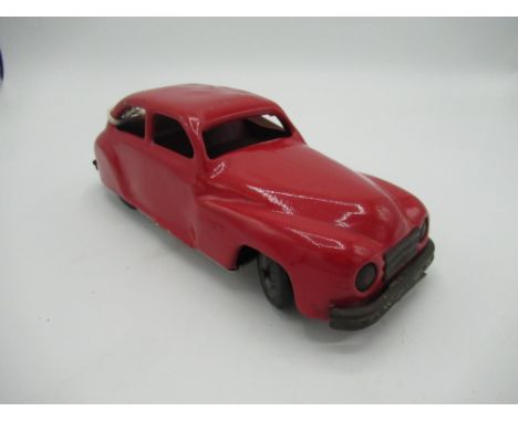 Chad Valley red tinplate clockwork saloon car with rubber tyres, L19cm 