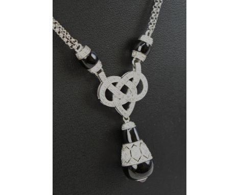 DIAMOND 'LOVERS KNOT' pendant necklace with an onyx, ruby and diamond pear drop, laid in white gold, marked 750, 00721. 