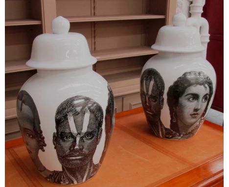 LIDDED URNS, a pair, Fornasetti style in white ceramic, 58cm H. (2)
