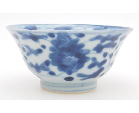 A Chinese porcelain tea bowl, in the Kangxi style, of lipped bellied circular outline, on a circular foot, heavily decorated 