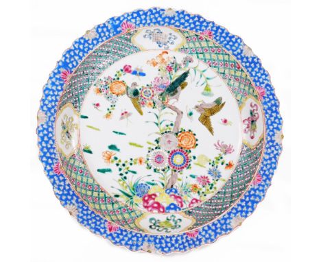 A Chinese Qing period porcelain charger, six character Kangxi mark beneath, polychrome decorated with a view of flowers and b