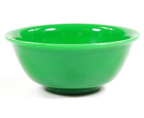 A fine Peking jade-green glass bowl, on a turned hardwood stand, 17cm dia., 7.5cm H.