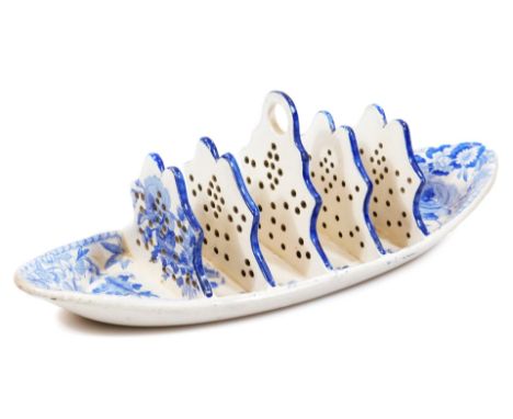 A 19thC Spode pottery blue and white toast rack, of boat shape with pierced supports, printed in blue and white with flowers 