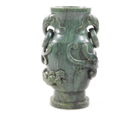 A polished jade coloured stone vase, of shaped outline with ring handles on an oval foot, 20cm H.