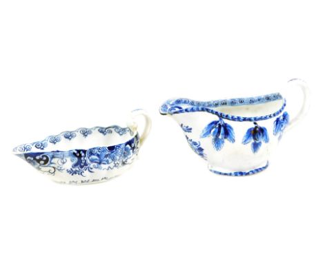 An 18thC Derby blue and white sauce boat, c.1770, decorated with a landscape to the bottom of the sauce boat below a C scroll