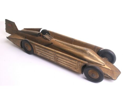 A tinplate c/w H.Segrave’s Land Speed Record Golden Arrow, German circa 1929, finished in gold with solid black tyres, Union 