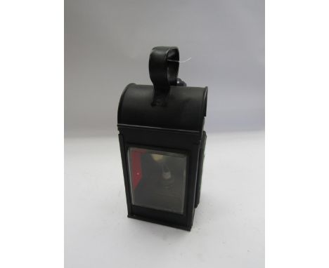 A black painted three aspect handlamp with red and clear aspects, copper resevoir and brass and ceramic burner