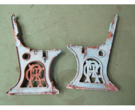 A pair of cast iron GER platform bench ends with the letters GER cast into the supports