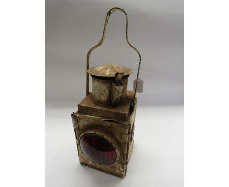 A white painted tail lamp with reservoir and metal burner