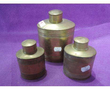 A set of vintage graduated copper canisters, impressed with size number to base