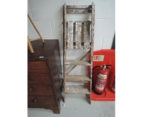 A set of vintage wooden decorators step ladders