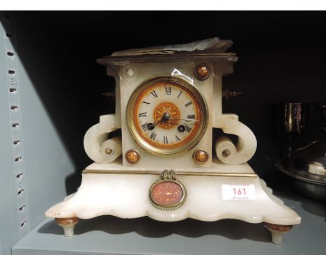 A 19th century alabaster mantel clock in the French style having striking movement