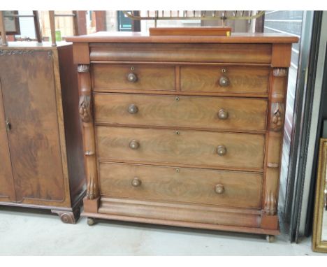 A Victorian mahogany Scotch type chest of drawers having fruit and paw claw decoration