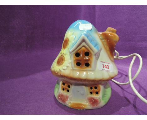 A vintage ceramic childrens bed side lamp as a fairy toadstool 