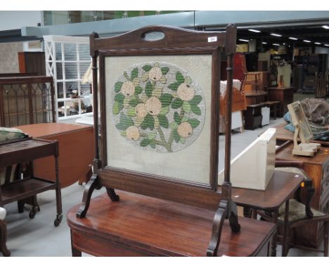 A vintage embroidered firescreen
