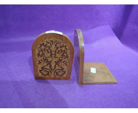 A pair of vintage portable bookends with marquetry bird inlay