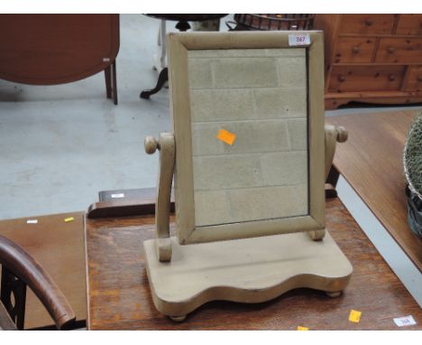 A light stained Victorian style toilet mirror