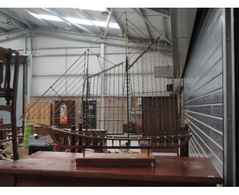 A vintage brass wirework model of ship on teak stand