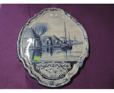 An antique large Delft wall hanging tile from Holland bearing mark to back, slight damage to some edge heavy earthen pottery