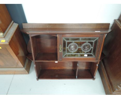 A Victorian mahogany wall shelf wih leaded glass cabinet section