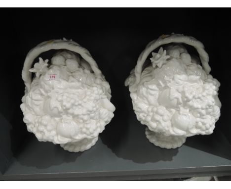 A pair of large ceramic fruit and flower basket decorations
