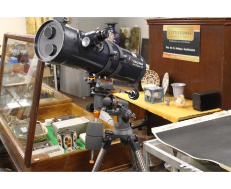 A TELESTRON ASTOMASTER 130 REFRACTING TELESCOPE ON TRIPOD STAND