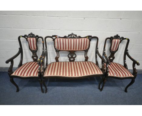 AN EARLY 20TH CENTURY MAHOGANY PARLOUR SUITE, with carved cresting rails, splat back and open armrests, comprising a two seat