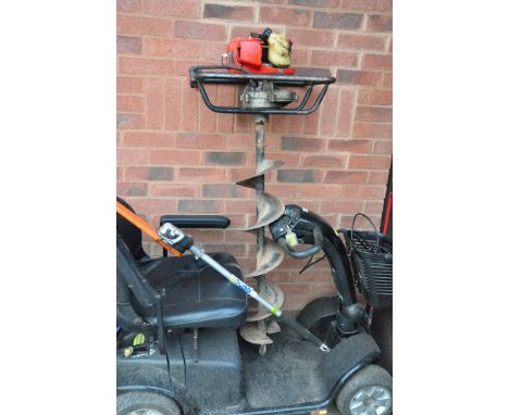 A CLARKE ED160 PETROL EARTH BORE with a 8in boring bit, (engine pulls freely but hasn't started, fuel leaks with carb) and a 