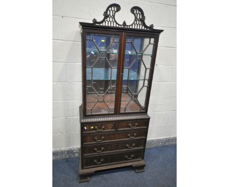 A GEORGIAN MAHOGANY ASTRAGAL GLAZED TWO DOOR DISPLAY CABINET, with an open fretwork swan neck pediment, the doors enclosing t