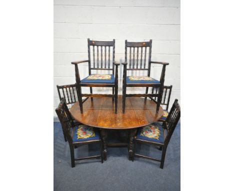 AN OAK BARLEY TWIST GATE LEG TABLE, open length 148cm x closed 53cm x 105cm x height 72cm, a six chairs with needlework drop 