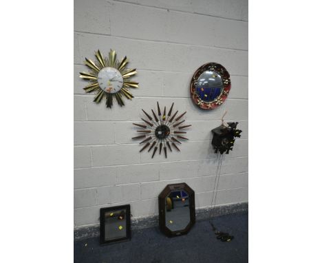 A MANLEY SUNBURST CLOCK, diameter 61cm, an Elexacta sunburst clock, a cuckoo clock with three weights, and three wall mirrors