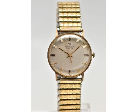 A 9CT GOLD 'MARVIN' WRISTWATCH, manual wind, round dial, signed 'Marvin Revue', baton markers, polished yellow gold case, app