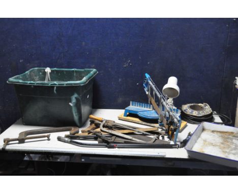 A BOX CONTAINING HAND TOOLS, to include saws, chisels, clamps, a mitre saw, wood dye, hand drill, rolls for, etc.