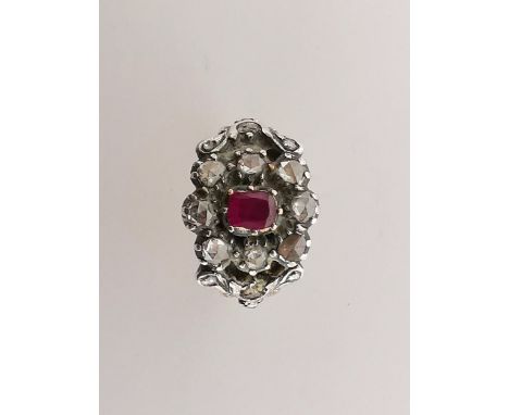 A 19th century gold ring set with a ruby surrounded by eight old cut diamonds, size O 