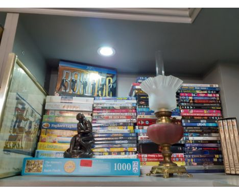 A quantity of games, VHS tapes, DVDs and other items to include a James Bond Blu-ray box set and an oil lamp Location: 10.1 