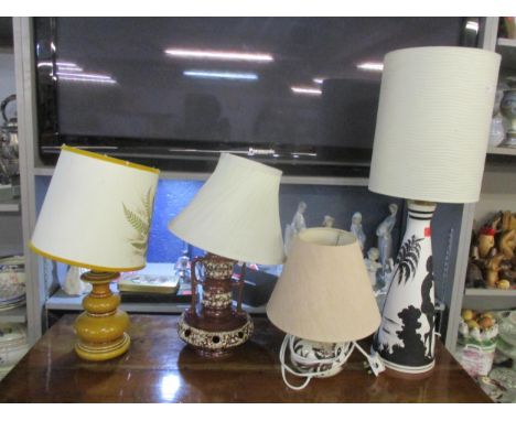 A group of four ceramic table lamps with fabric shades to include a German fat lava lamp and a Cyprus lamp Location:
