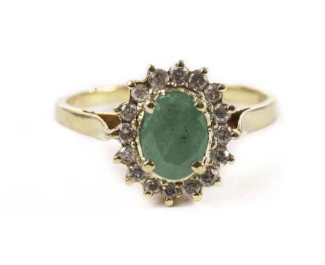 An emerald and diamond cluster ring, on yellow metal mount 