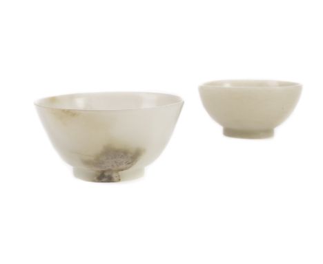 A 18th/19th century Chinese pale celadon jade bowl with slightly flared sides on short foot rim, the body with natural inclus