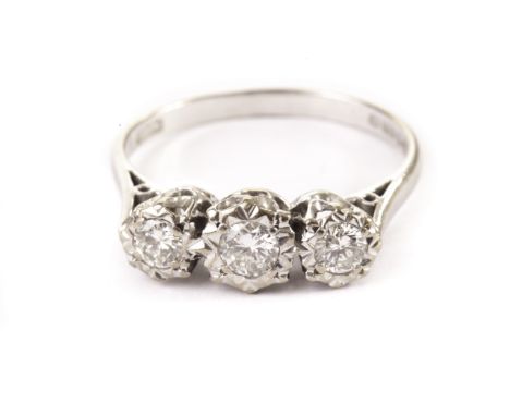 An 18ct gold three stone diamond ring, having graduated brilliant cuts in illusion white gold settings, hallmarked 