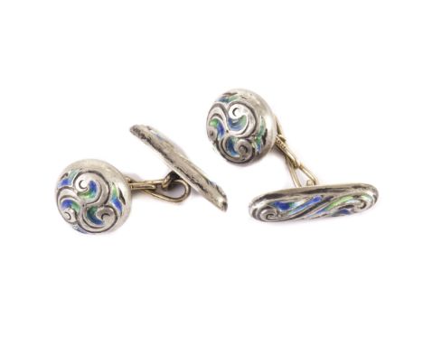 A rare pair of Art Nouveau silver and enamel cufflinks from Liberty & Co, having a circular button with green and blue design