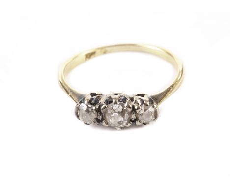 A vintage three stone diamond engagement ring, with old cut stones in platinum claws on a probably 18ct gold band 