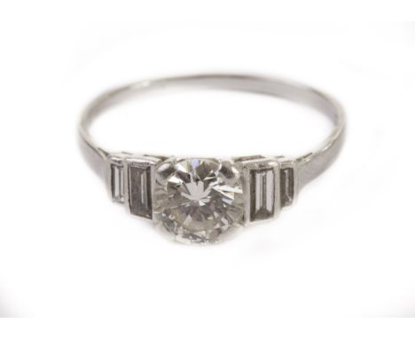 A pretty Art Deco period diamond engagement ring, with a good quality approx 1ct brilliant cut in platinum mount having two g