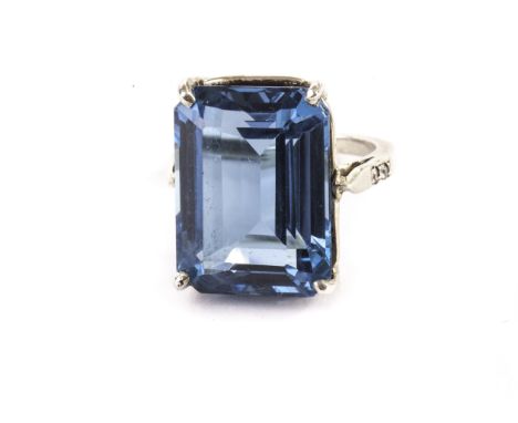 A silver and paste dress ring, having a large blue rectangular stone in four claw mount, marked 925 