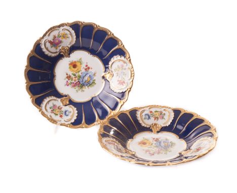 A pair of Dresden cabinet dishes, with printed floral design to a deep blue ground, edged in matt gilt 29cm dia. (2) 