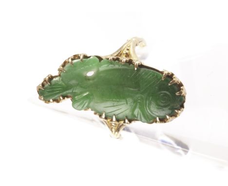 A fine Chinese gold and jade dress ring, the 10k gold mount with a carved and engraved panel in the form of a fish 