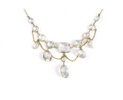 A pretty Art Deco aqua marine fringe necklace, the light blue faceted cut stone and drop pendant in gilt frames, on a fine gi