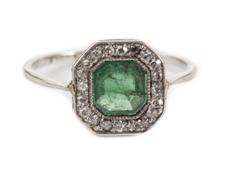 An Art Deco emerald and diamond dress ring, the octagonal tablet set with eight cuts with central green stone, AF, in a white