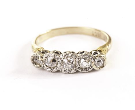 An Art Deco period five stone diamond engagement ring, having old cut stones in platinum illusion mounts on an 18ct gold band