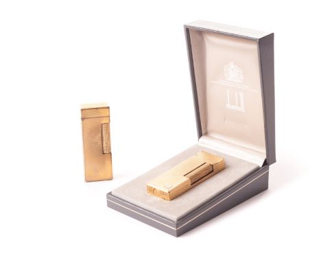 Two Dunhill cigarette lighters, both gilt engine turned examples, one in Dunhill box (3) 
