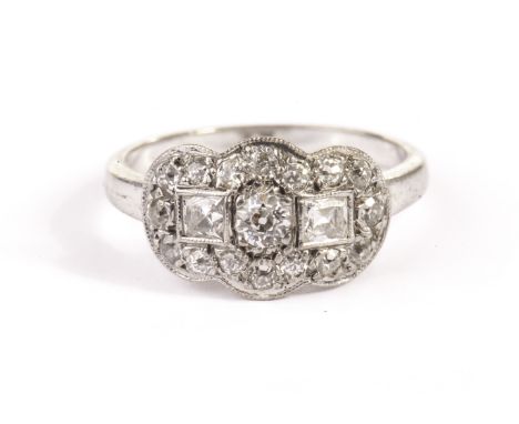 A pretty Art Deco period diamond dress ring, the shaped tablet centred with an old cut and a pair of princess cuts surrounded